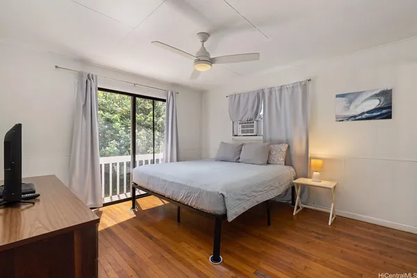 a bedroom with a bed and a flat screen tv