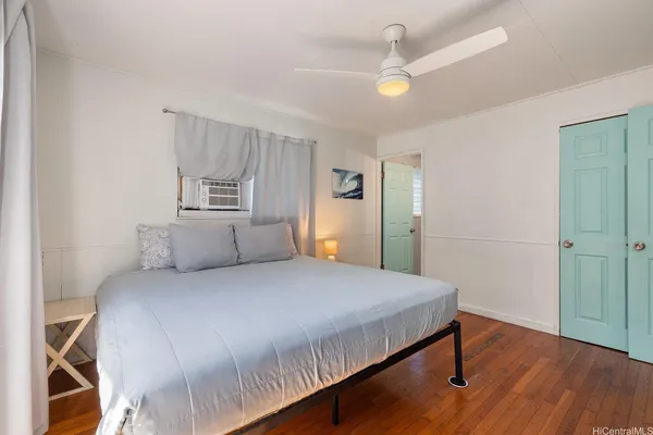 a bedroom with a bed and a chandelier