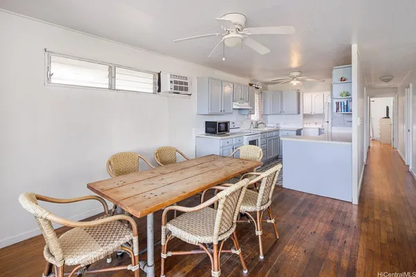 a view of a dining room with furniture and wooden floor