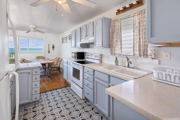 a kitchen that has a sink and a stove
