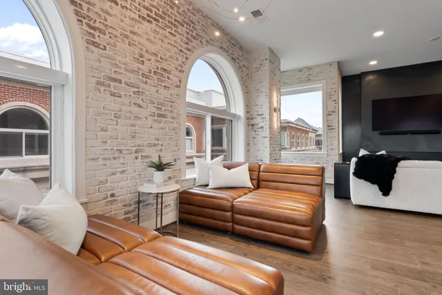 a view of a livingroom with furniture and windows