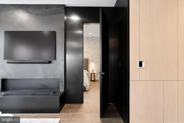 a spacious bedroom with a bed and a chair