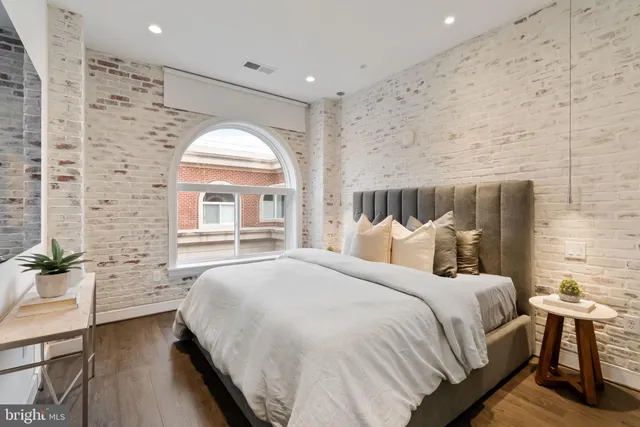 a bedroom with a bed and a large mirror