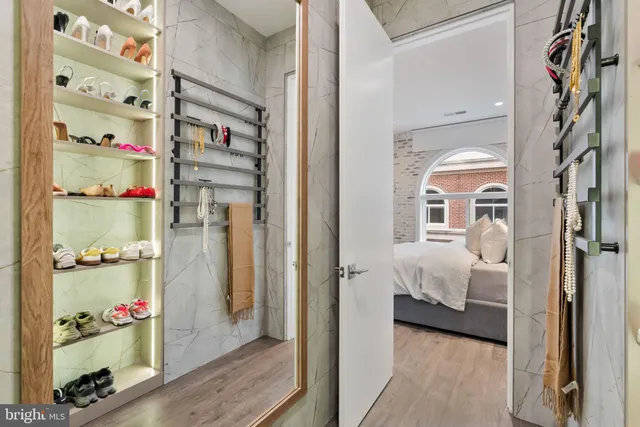 a bathroom with a granite countertop sink a mirror and a shower