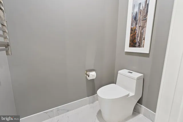a living room with a flat screen tv and a floor to ceiling window