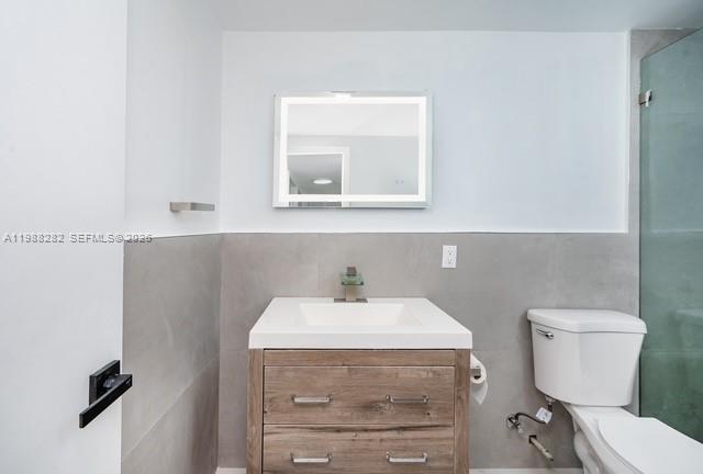 9760 Southwest 184th Street, Unit 6D Cutler Bay, FL 33157 - Photo 11 of 16 a bathroom with a sink toilet and mirror