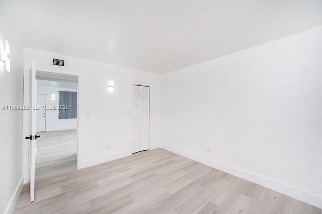 9760 Southwest 184th Street, Unit 6D Cutler Bay, FL 33157 - Photo 2 of 16 an empty room with wooden floor and white walls