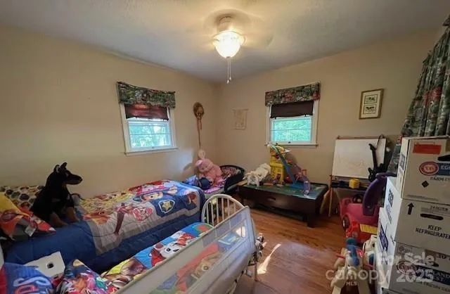 a bedroom with bed and a chandelier