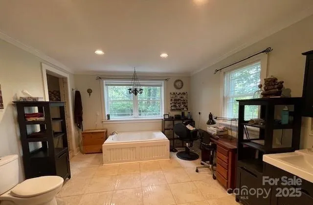 a living room with furniture a window and a flat screen tv