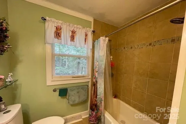a bathroom with a shower and a toilet