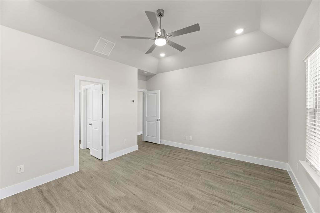 2372 Bell Way Forney, TX 75126 - Photo 30 of 39 an empty room with wooden floor and ceiling fan
