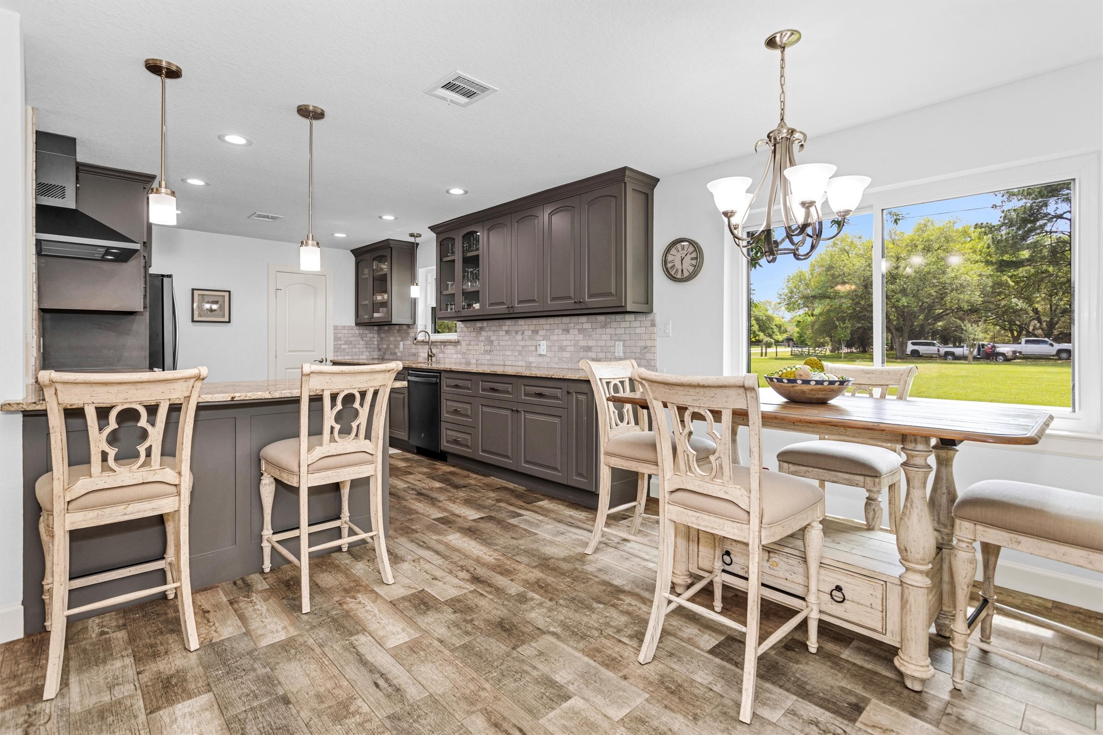 4402 Spears Road Manvel, TX 77578 - Photo 17 of 38 a dining room with furniture a chandelier and kitchen view
