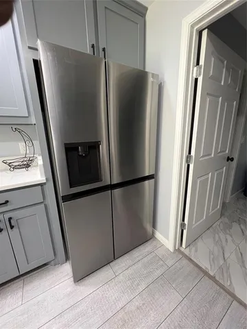 a kitchen with metallic refrigerator freezer and a dishwasher