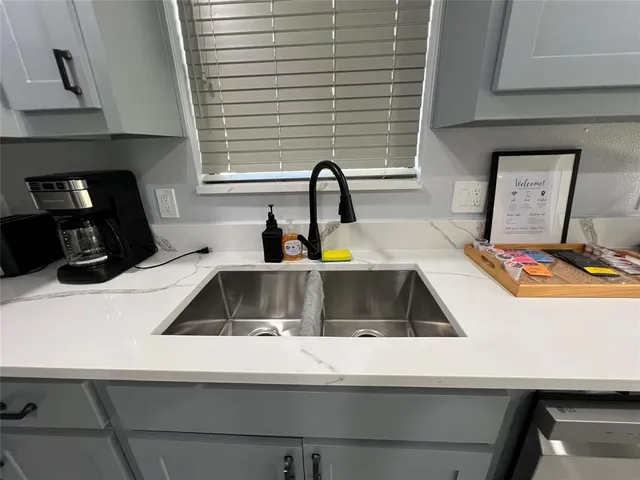 a kitchen with a sink and a stove