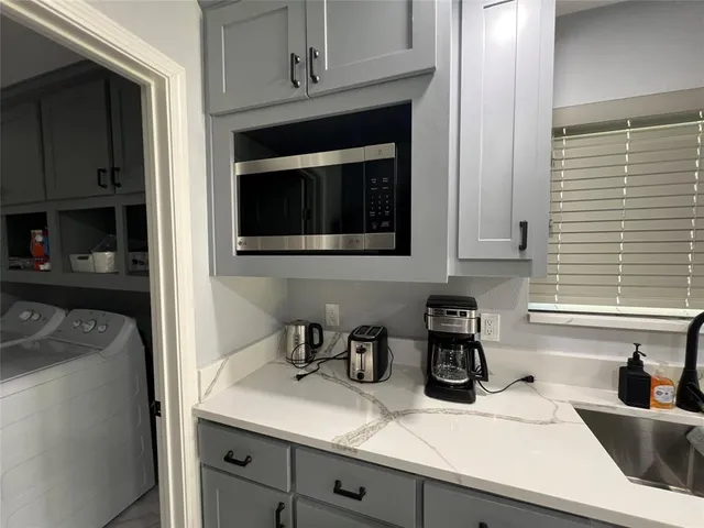 a kitchen with a sink cabinets and a window