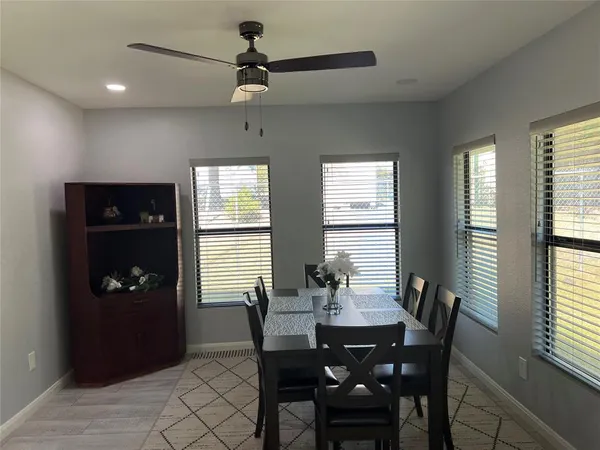 a dining room with furniture and window