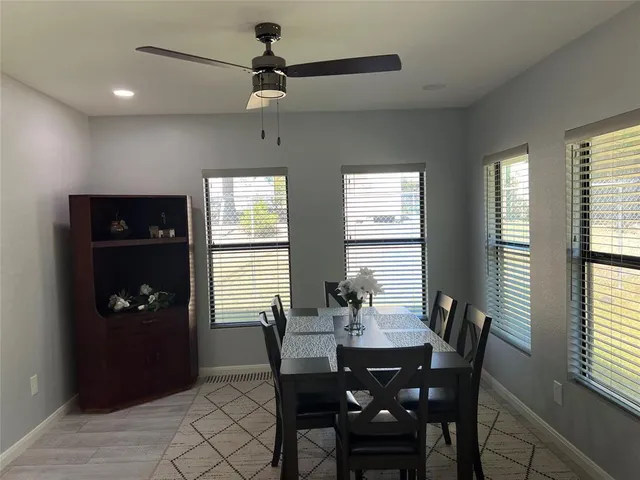 a dining room with furniture and window