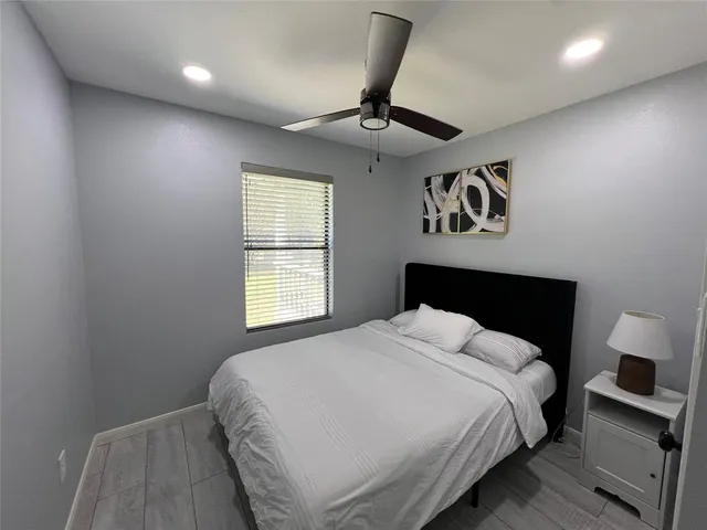 a bedroom with a large bed and a chandelier