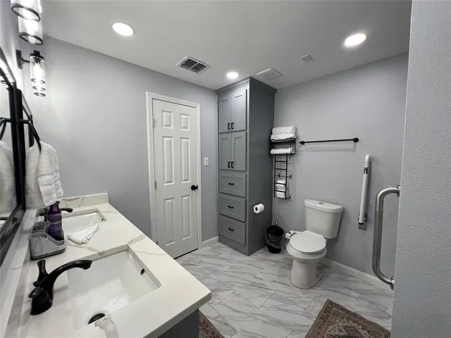 a bathroom with a sink toilet and shower