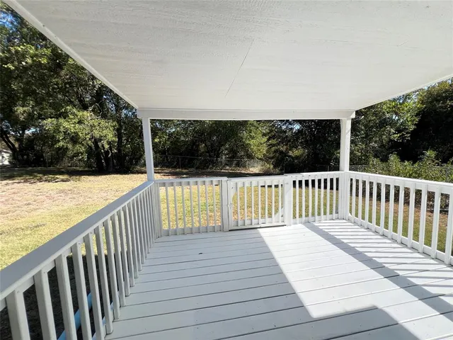 a view of balcony with wooden floor