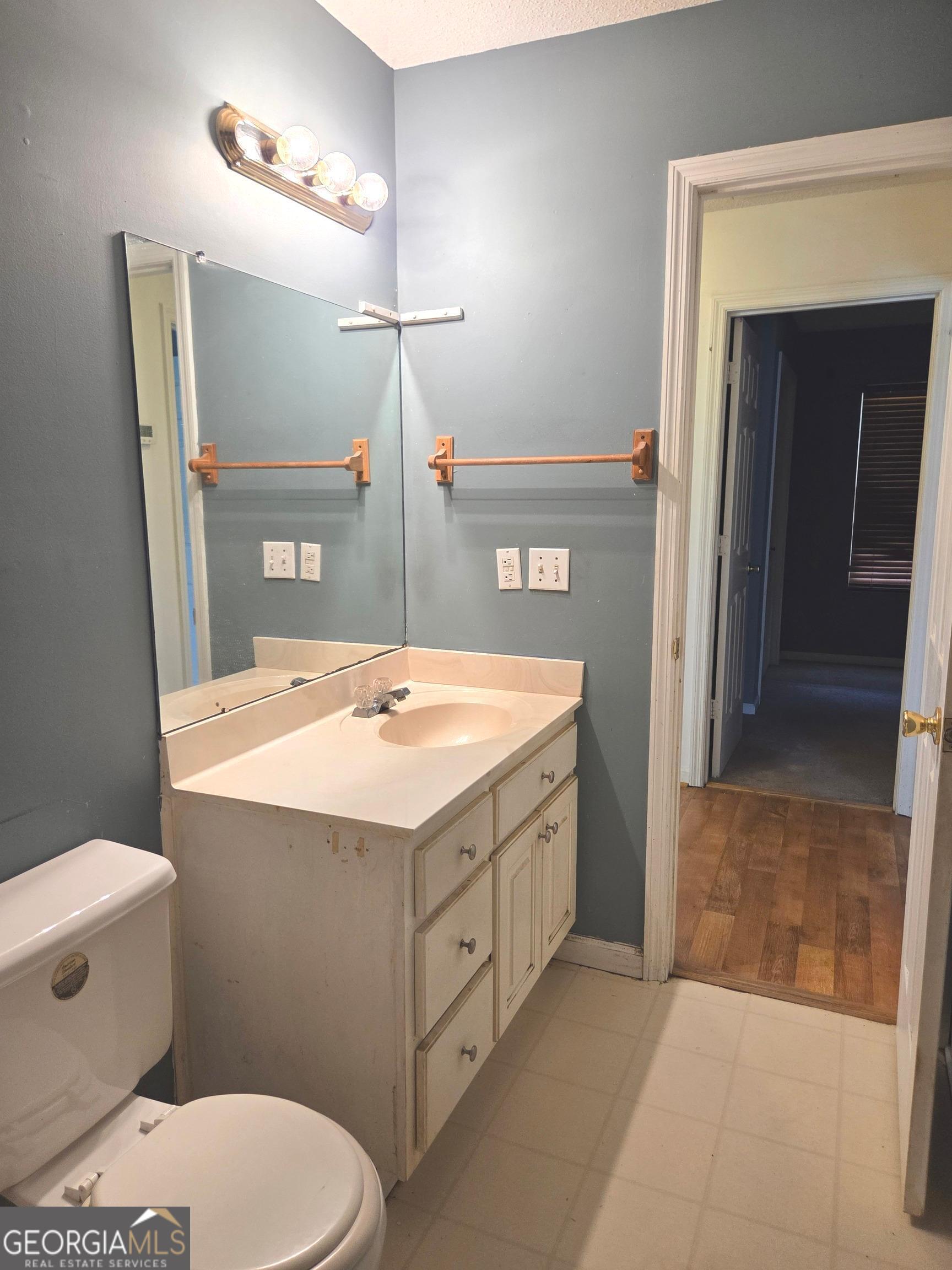 9546 Union Road Metter, GA 30439 - Photo 19 of 45 a bathroom with a sink a toilet a mirror and shower