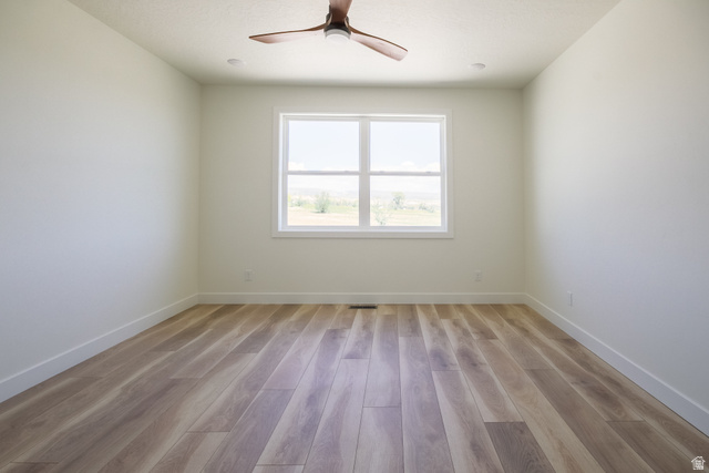 3322 250 S Street Vernal, UT 84078 - Photo 20 of 37 Spacious room featuring wood-finish flooring and a large window
