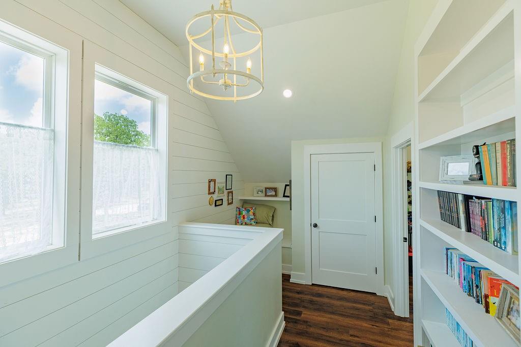 2094 Jim Harry Loop Sunset, TX 76270 - Photo 23 of 40 upstairs landing with built-in bookshelves and book nook