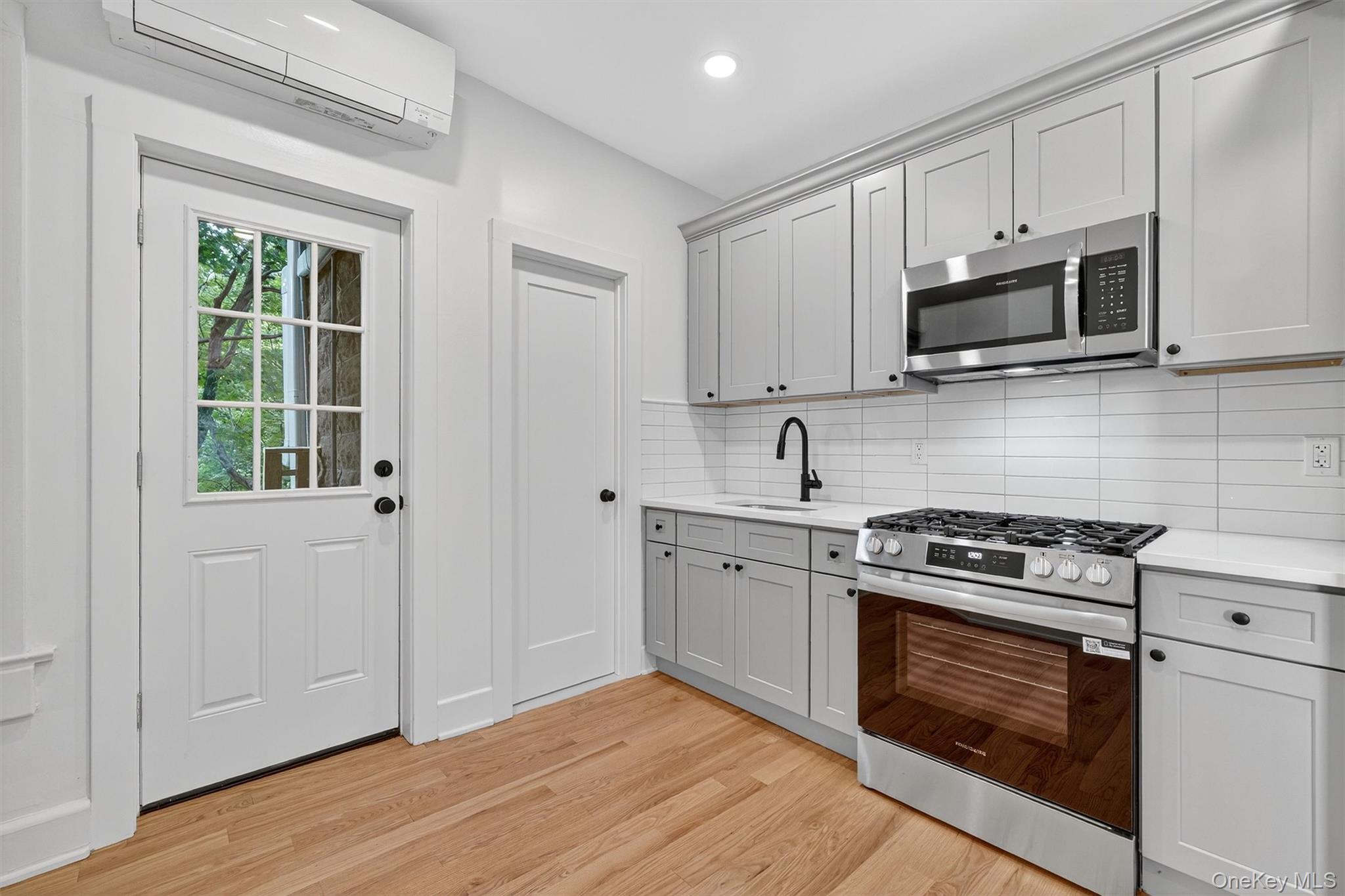 79 Main Street, Unit 2W Ossining, NY 10562 - Photo 6 of 17 Kitchen with hardwood floors, door to balcony.