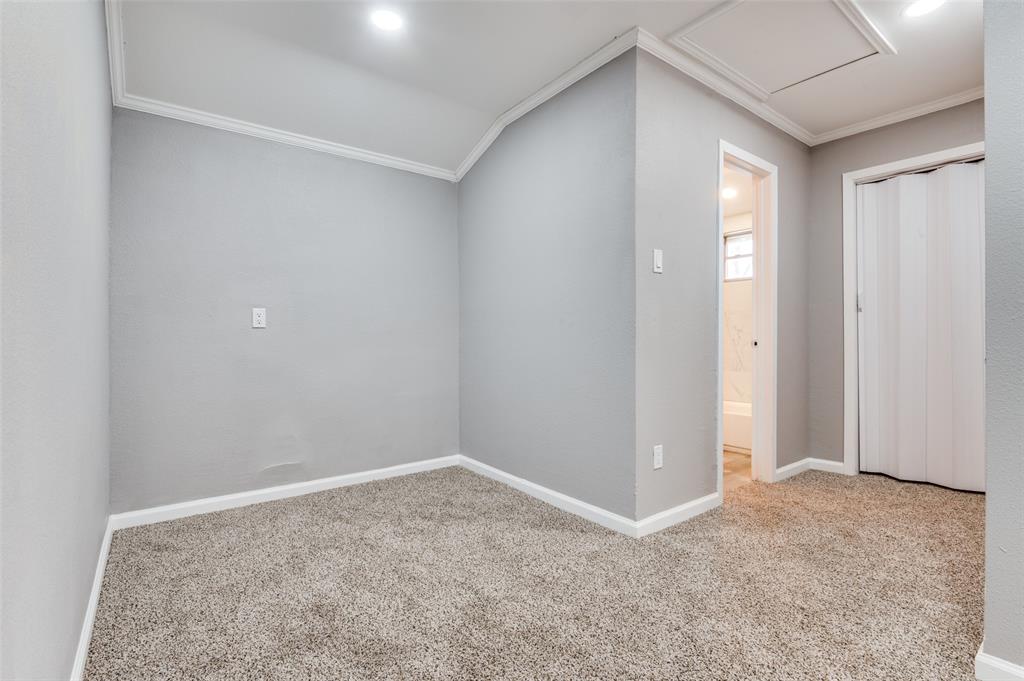 421 West 8th Street Lancaster, TX 75146 - Photo 16 of 28 Carpeted room with light gray walls, white baseboards, and white crown molding