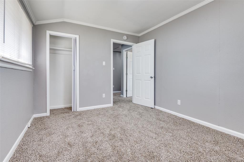 421 West 8th Street Lancaster, TX 75146 - Photo 20 of 28 Light gray painted walls with white trim, featuring carpet flooring and a window with blinds