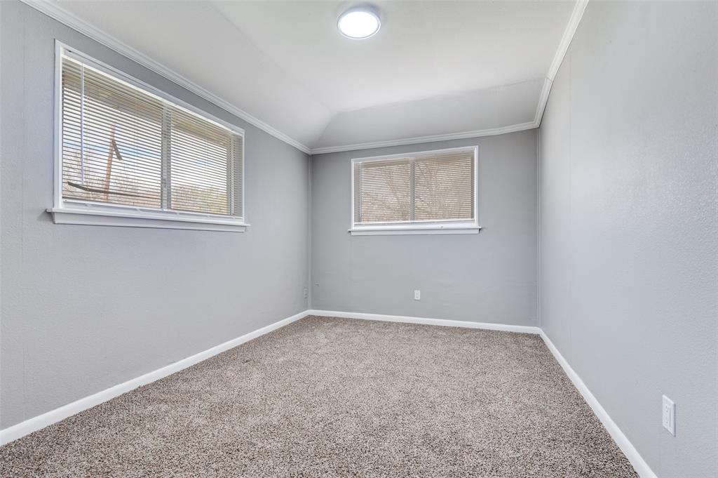 421 West 8th Street Lancaster, TX 75146 - Photo 21 of 28 Room featuring two windows with blinds, gray textured walls, and brown carpet flooring
