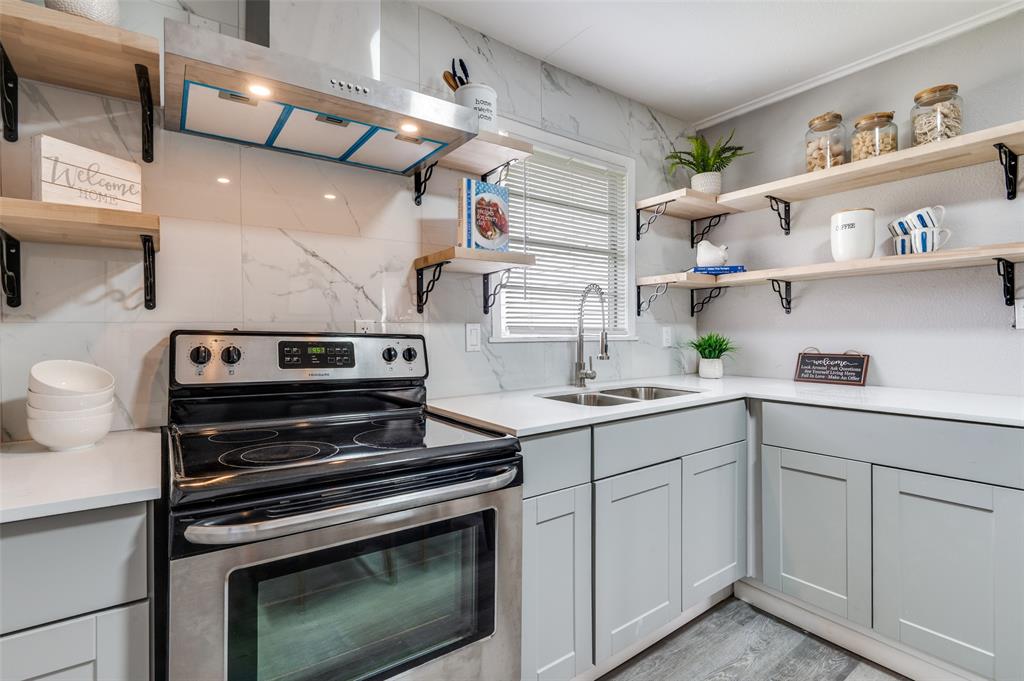 421 West 8th Street Lancaster, TX 75146 - Photo 7 of 28 Modern kitchen featuring light gray cabinetry, white countertops, a stainless steel electric range, and a dual-basin stainless steel sink with a gooseneck faucet