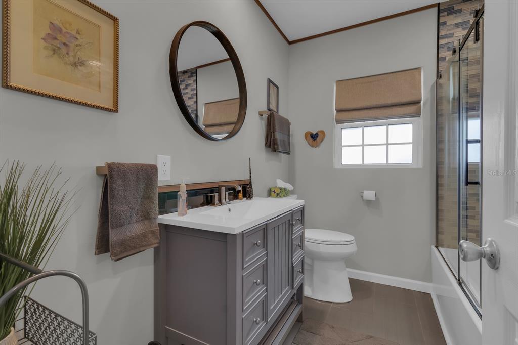 1322 Riverside Drive Titusville, FL 32780 - Photo 13 of 21 a bathroom with a toilet a sink and a mirror