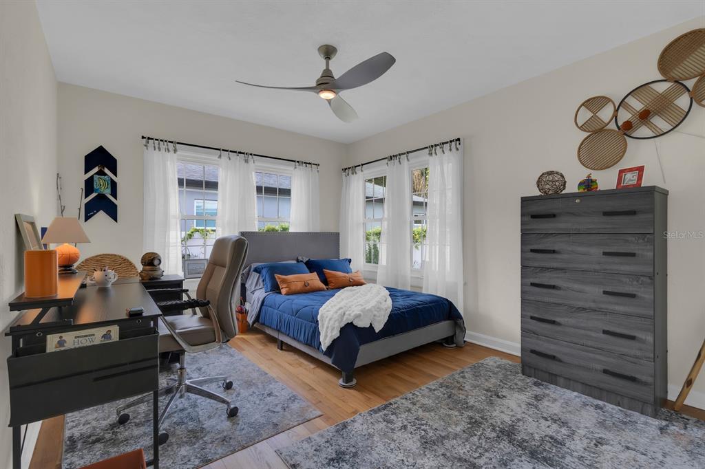 1322 Riverside Drive Titusville, FL 32780 - Photo 14 of 21 a bedroom with a bed and wooden floor