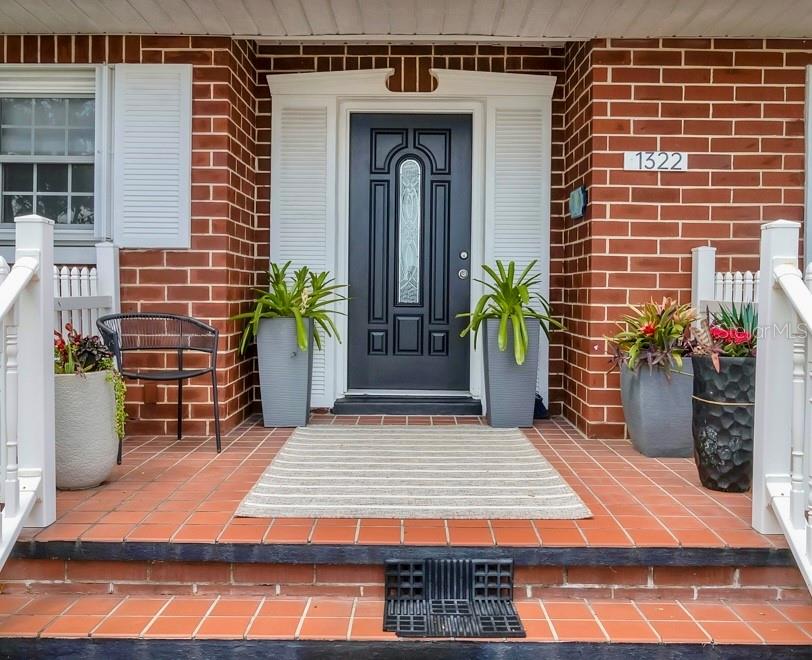 1322 Riverside Drive Titusville, FL 32780 - Photo 2 of 21 a front view of a house with potted plants