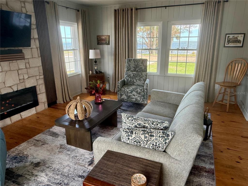 1322 Riverside Drive Titusville, FL 32780 - Photo 8 of 21 a living room with furniture fireplace and flat screen tv