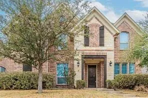 front view of a house with a tree