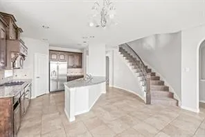 a view of a kitchen with furniture and staircase