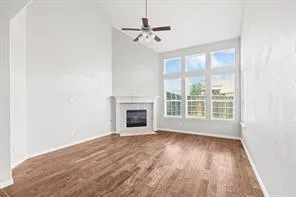 a view of a livingroom with a ceiling fan and window