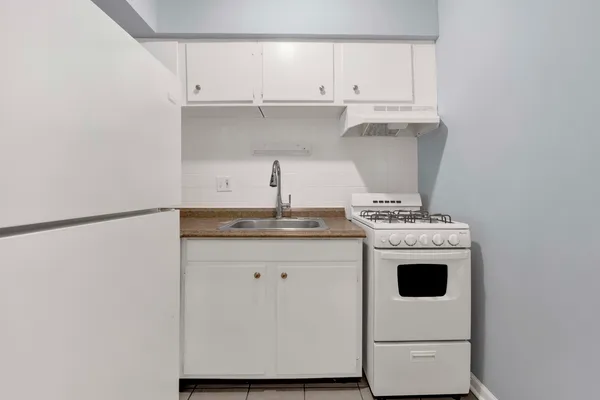 a kitchen with stainless steel appliances a sink a stove and a refrigerator