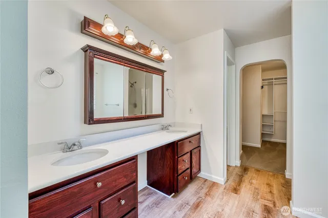 a bathroom with a sink a light fixture and a mirror