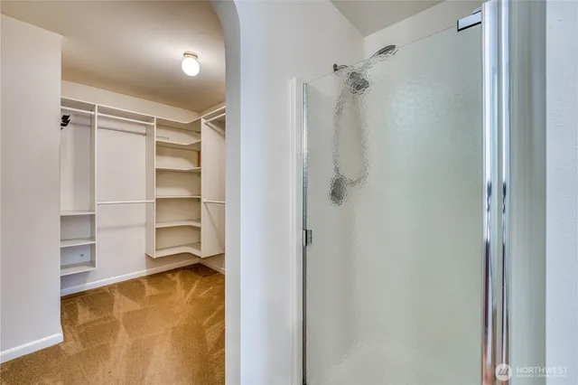 a view of walk in closet with empty racks