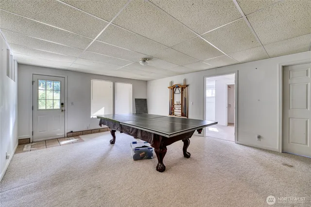 a room with pool table and windows