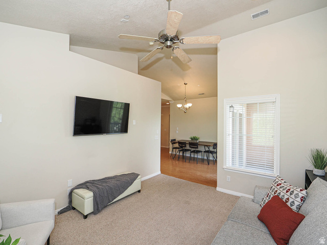 1138 Meadow Fork Road, Unit 7 Provo, UT 84606 - Photo 8 of 27 Vaulted ceiling with a ceiling fan, carpeted flooring, and a window with blinds