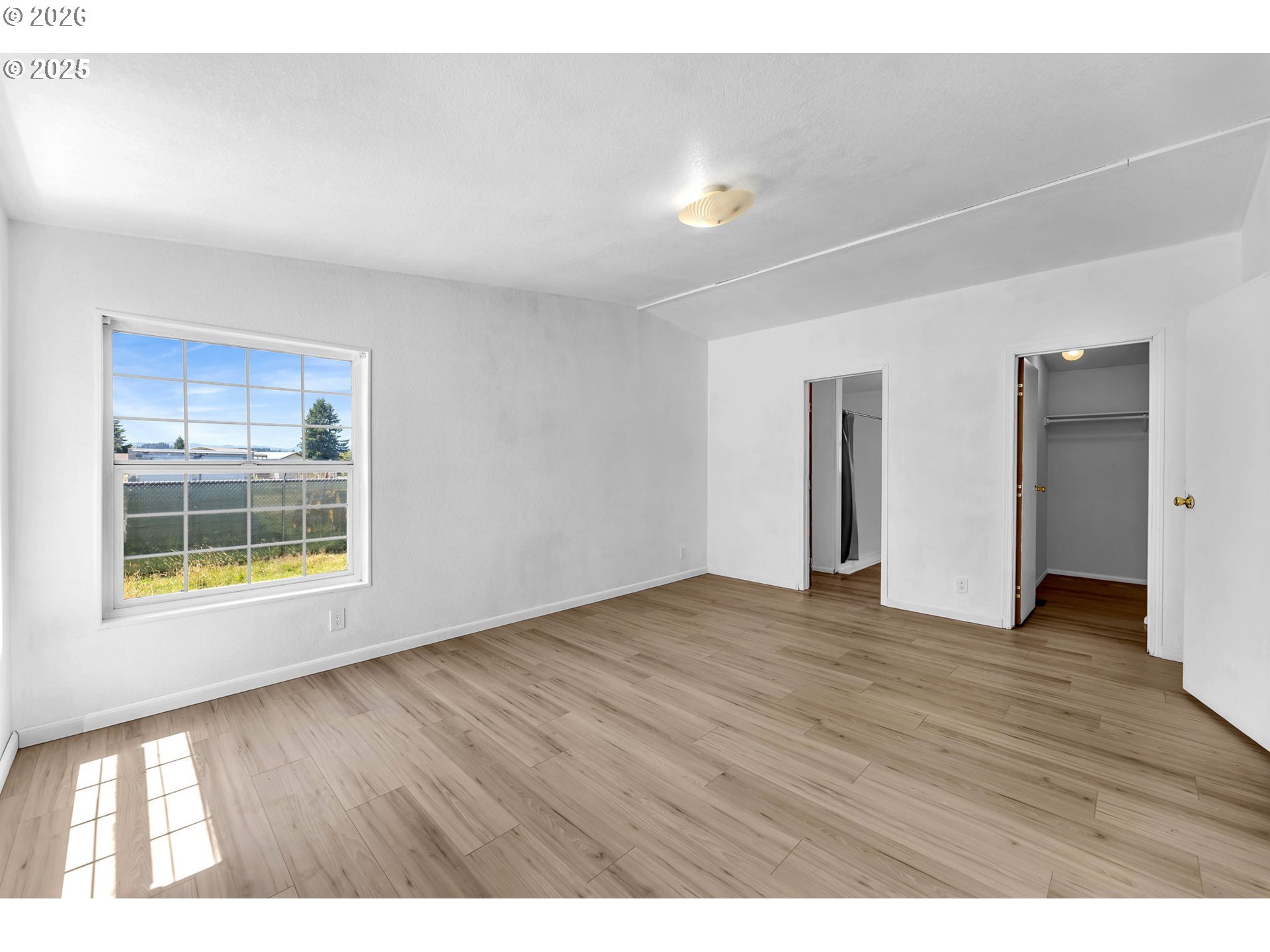 241 Foster Creek Road Toledo, WA 98591 - Photo 11 of 17 a view of an empty room with wooden floor and windows