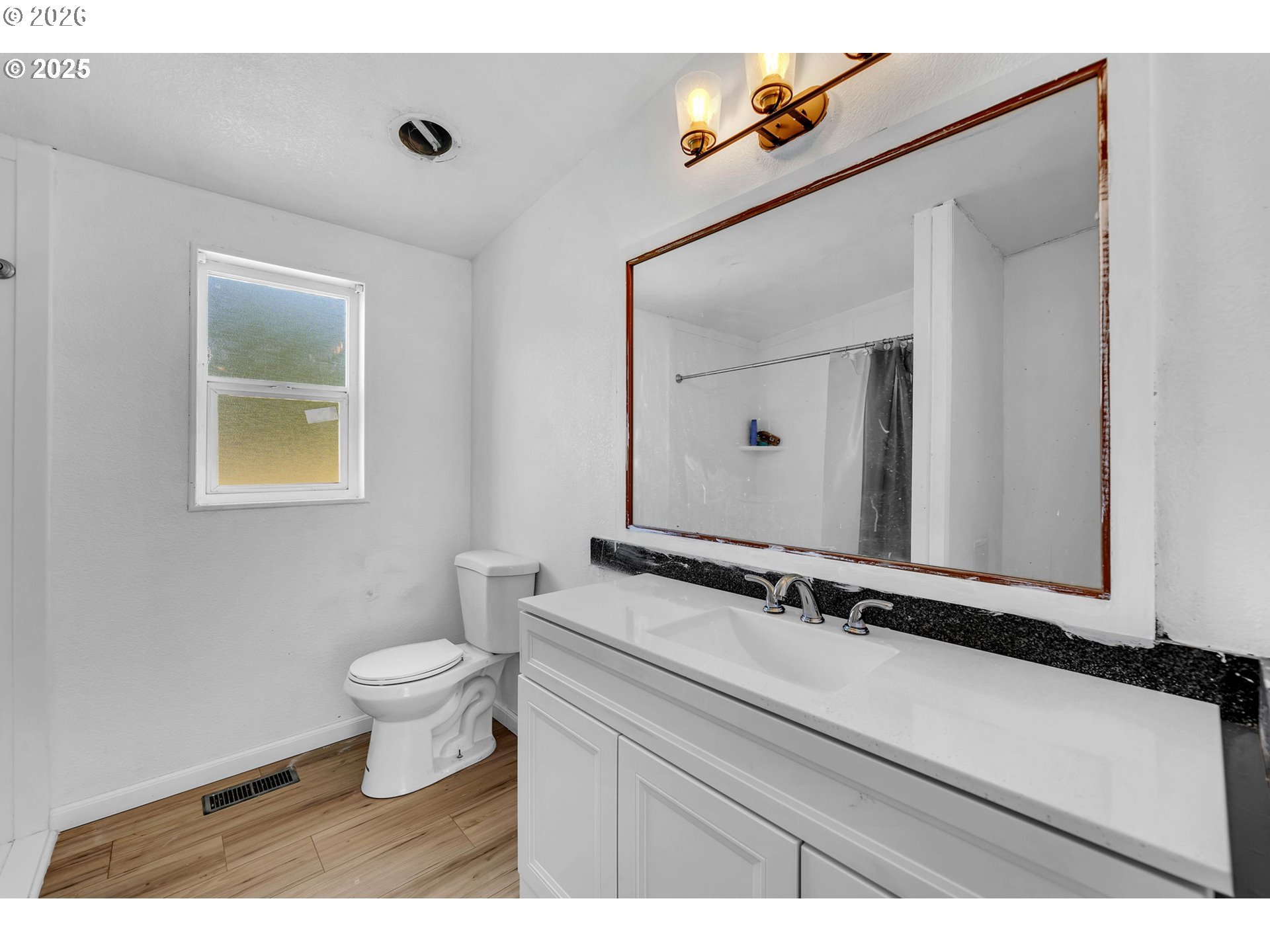 241 Foster Creek Road Toledo, WA 98591 - Photo 15 of 17 a bathroom with a toilet a sink and mirror