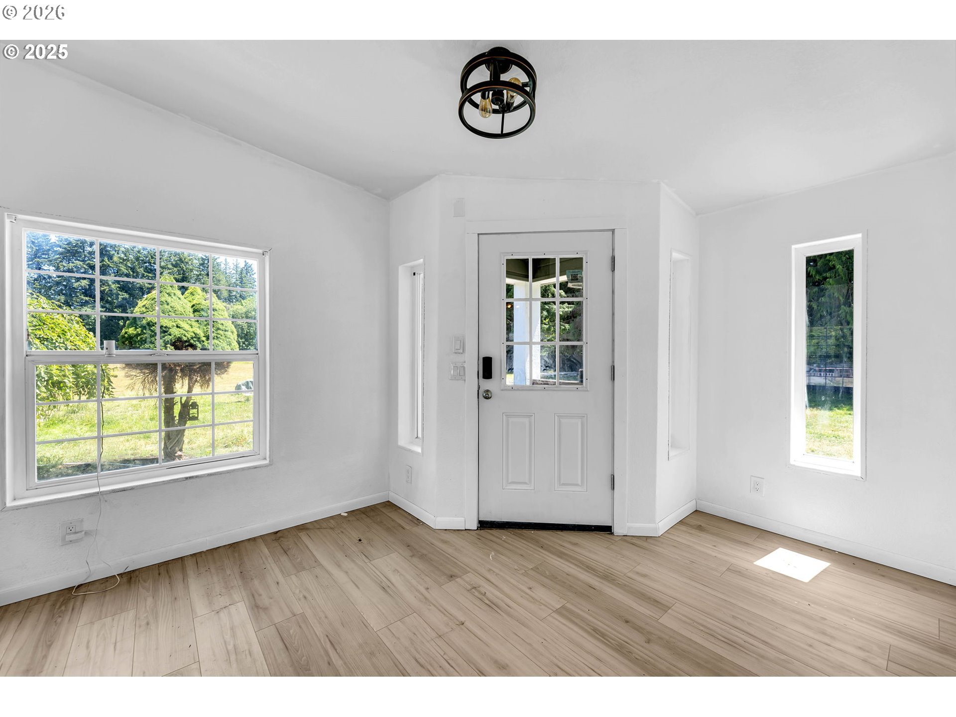 241 Foster Creek Road Toledo, WA 98591 - Photo 5 of 17 an empty room with wooden floor and windows