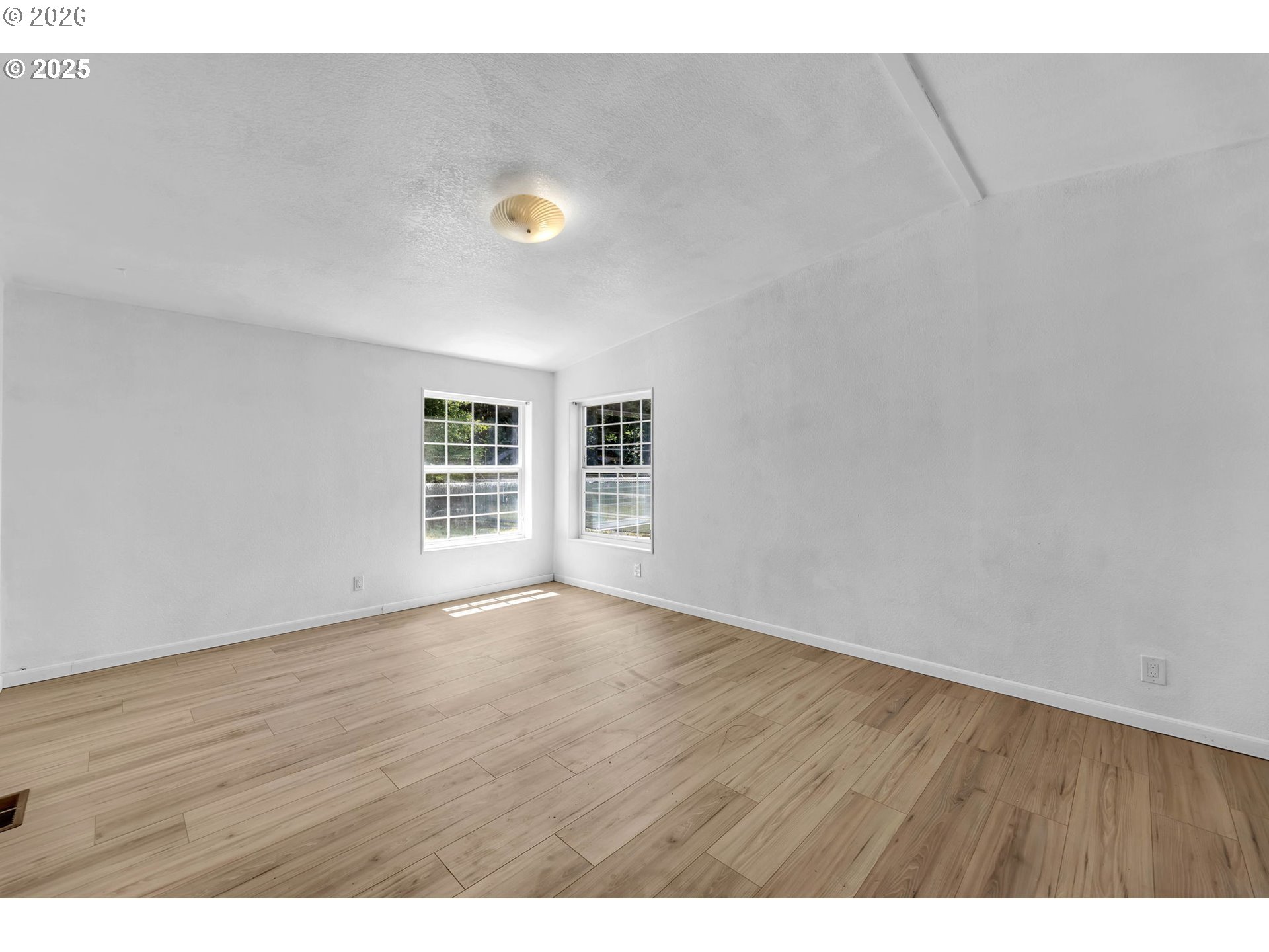 241 Foster Creek Road Toledo, WA 98591 - Photo 6 of 17 a view of an empty room with wooden floor and a window