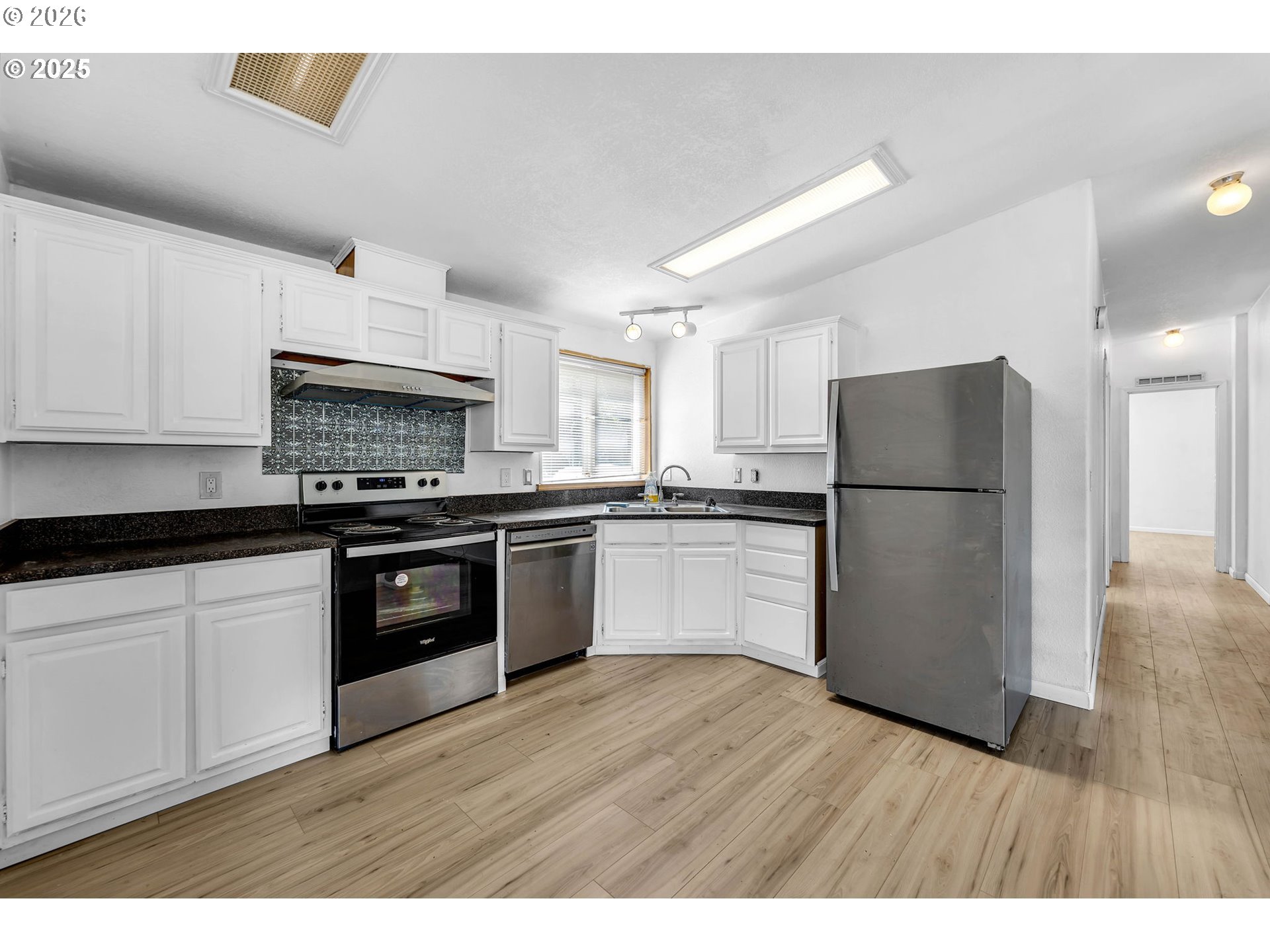 241 Foster Creek Road Toledo, WA 98591 - Photo 8 of 17 a kitchen with granite countertop white cabinets and stainless steel appliances