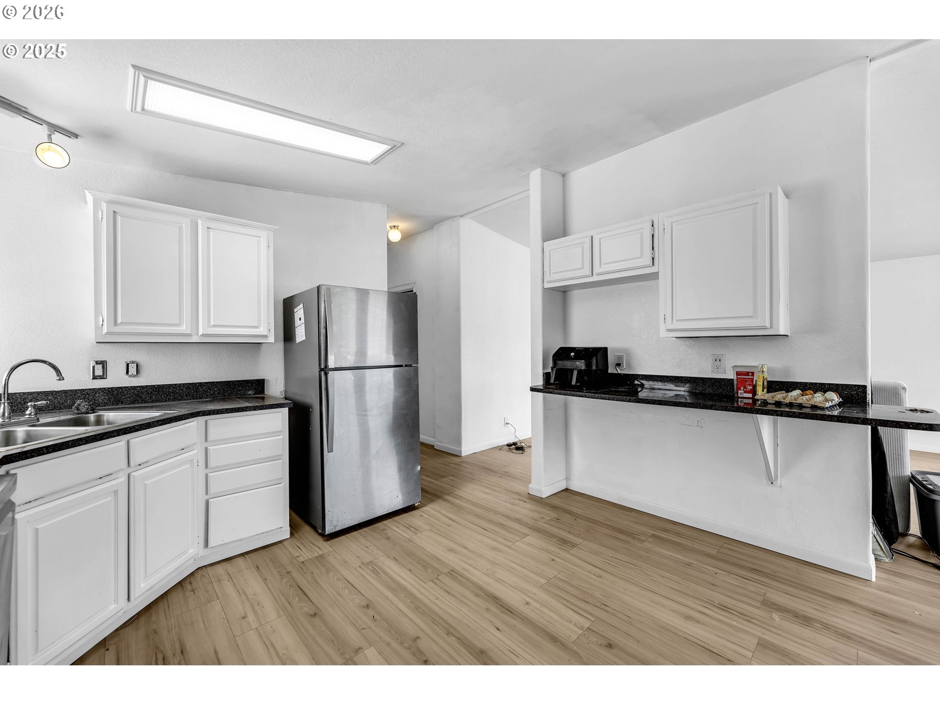 241 Foster Creek Road Toledo, WA 98591 - Photo 9 of 17 a kitchen with stainless steel appliances granite countertop a refrigerator sink and white cabinets